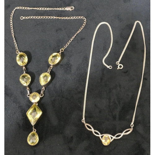 495 - A citrine and silver drop necklace with chain and another silver drop pendant mounted with citrine s... 