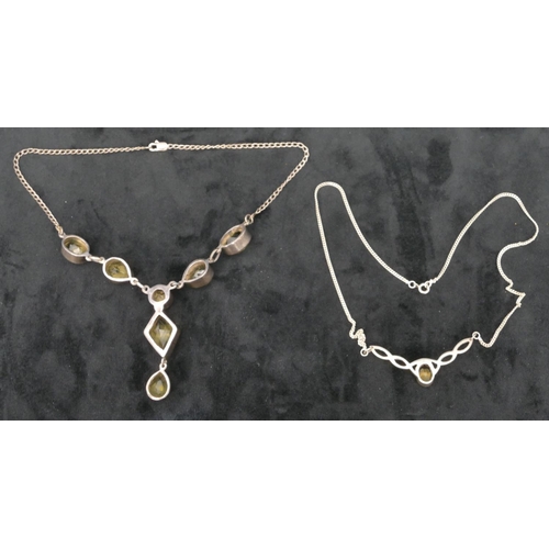 495 - A citrine and silver drop necklace with chain and another silver drop pendant mounted with citrine s... 