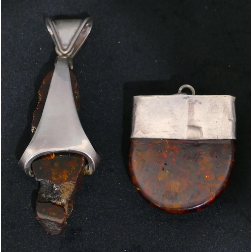 504 - A silver and amber drop pendant, 8cm long and another silver and amber drop pendant. (2)