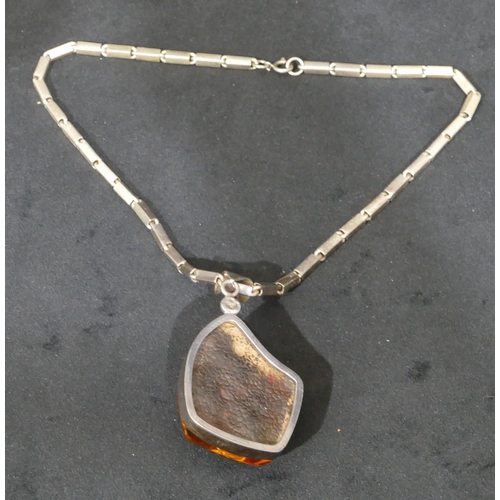 505 - A silver and large amber nugget pendant with square silver chain, 46cm long.