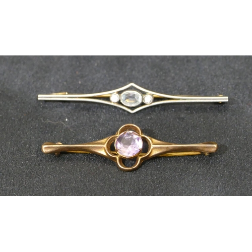 509 - A 9ct gold bar brooch set with centre purple stone and another gold bar brooch. (2)