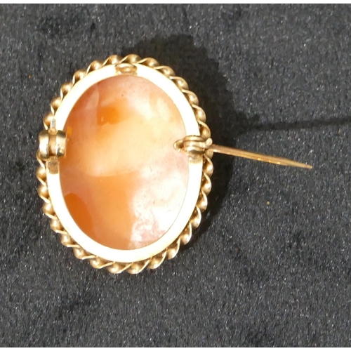 510 - A small gold cameo pendant/brooch with raised figurehead of a lady, 3cm high, 4.4 grams gross.