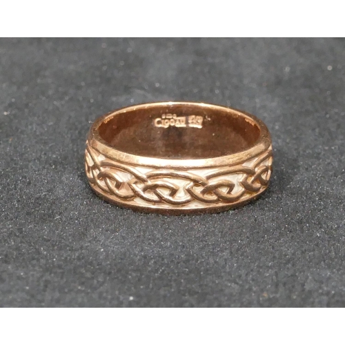 511 - A 9ct gold Clogau wedding ring with raised scroll rim, size X/Y, 9.1 grams, with original box.