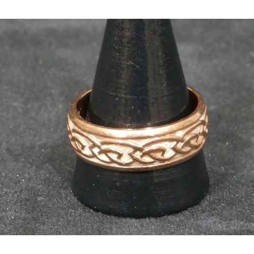 511 - A 9ct gold Clogau wedding ring with raised scroll rim, size X/Y, 9.1 grams, with original box.