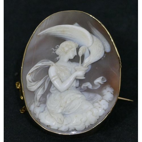 514 - A 19th Century gold oval cameo with carved figure of a kneeling lady and bird motif, 6cm high.