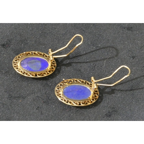 518 - A pair of 14ct gold oval earrings set with centre lapis lazuli, with pierced rims, 3.5cm high, 9.4 g... 