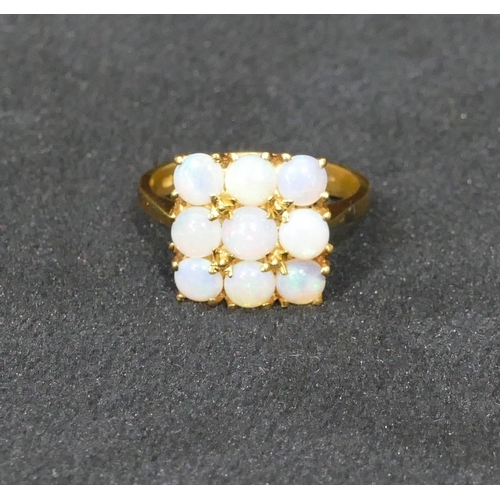 522 - An 18ct gold square ladies cluster ring set with 9 opals, size N/O, 5.2 grams gross.