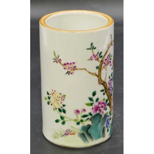 54 - An Oriental cylindrical brush pot on white ground with multi-coloured bird, branch and floral decora... 