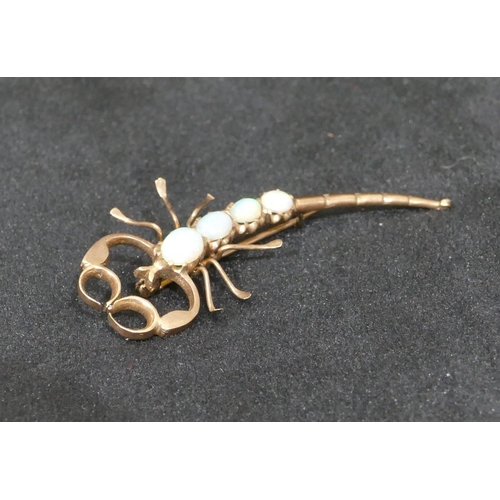 540 - A gold brooch in form of a scorpion mounted with opals, 5.5m long, 3.7 grams gross.