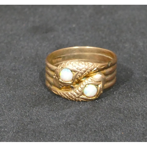 549 - A 9ct gold twist serpent ring set with 2 opals, size Y, 7.4 grams gross.