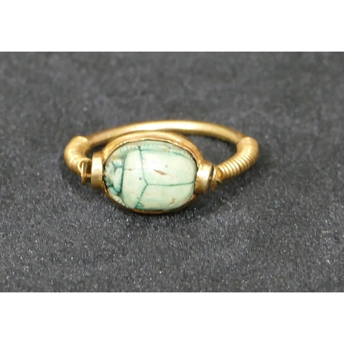 550 - An Egyptian high ct gold  scarrab ring, size O, 3.8 grams gross.