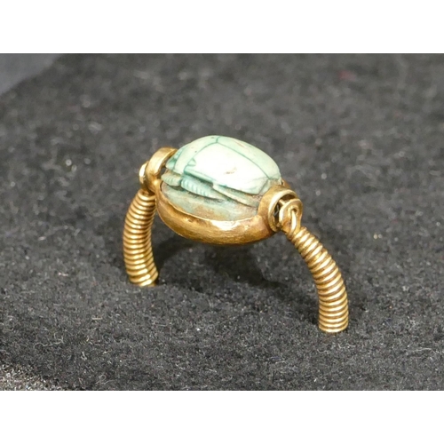 550 - An Egyptian high ct gold  scarrab ring, size O, 3.8 grams gross.