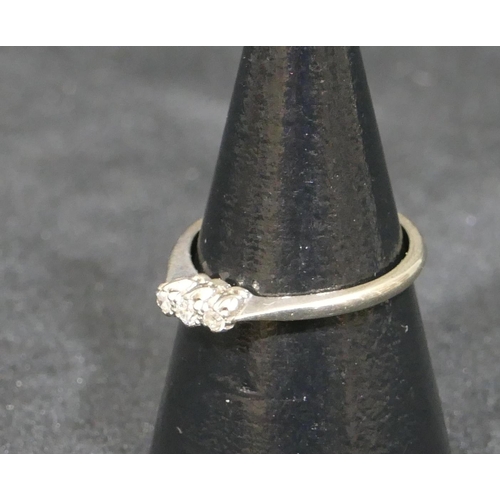 553 - An 18ct white gold ladies small 3-stone diamond ring, size L/M, 2.1 grams gross.