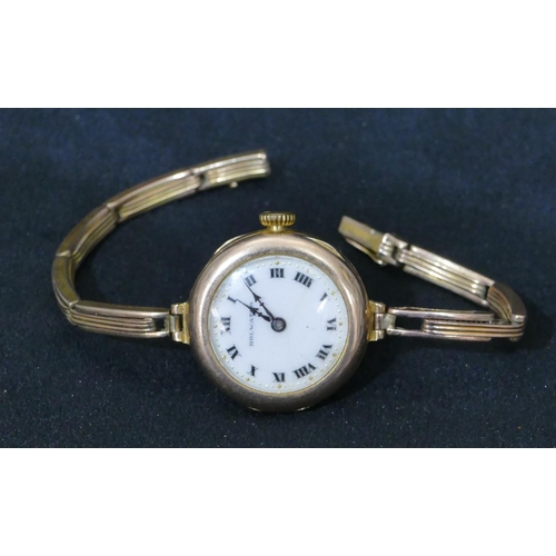 557 - A 9ct gold Rolwatcho circular faced wristwatch with matching strap bracelet, white enamel dial with ... 