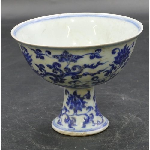 56 - An Oriental round trumpet shaped cup on blue and white ground with phoenix, floral and scroll decora... 