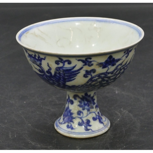 56 - An Oriental round trumpet shaped cup on blue and white ground with phoenix, floral and scroll decora... 