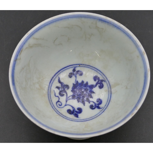 56 - An Oriental round trumpet shaped cup on blue and white ground with phoenix, floral and scroll decora... 