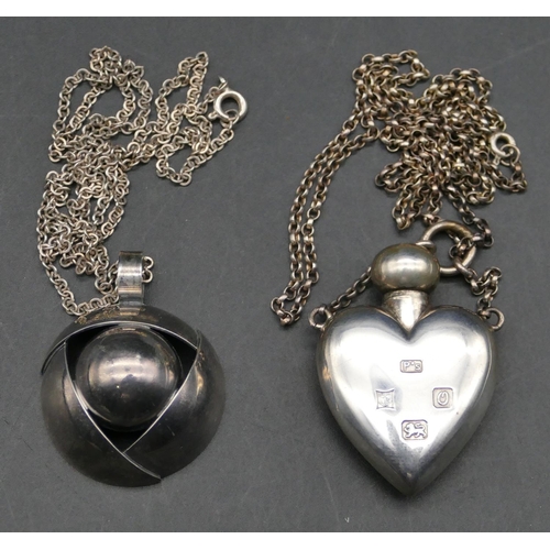 566 - A silver heart shaped scent bottle pendant with chain and another silver circular pendant with chain... 