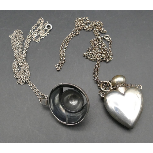 566 - A silver heart shaped scent bottle pendant with chain and another silver circular pendant with chain... 