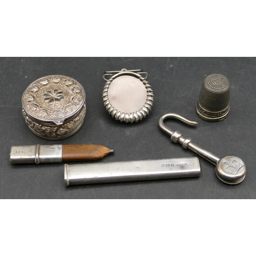 572 - A silver pendant hook, a silver pencil in matching sheath, a Birmingham silver thimble, a pill box w... 