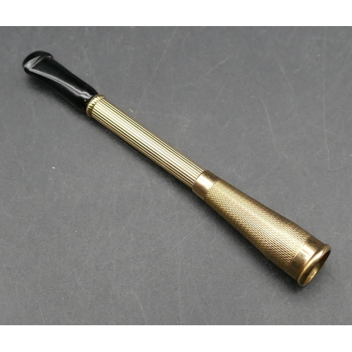 579 - A 9ct gold cheroot holder with piercing centre and black mouthpiece, 8cm long, 7.9 grams gross.