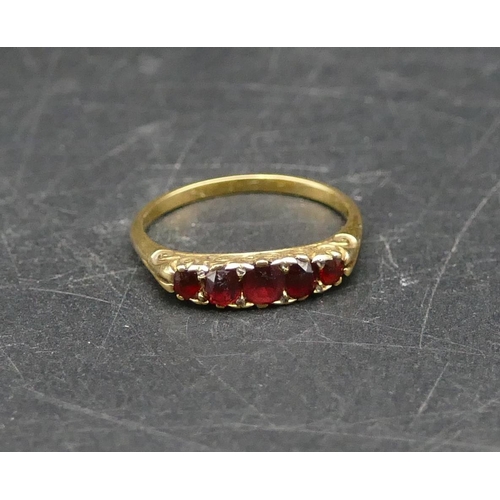 583 - A ladies gold 5 stone ring set with graduated garnets, Size O/P, 2.8 grams gross