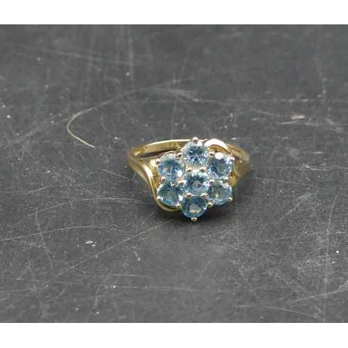 592 - A 9ct gold ladies cluster ring set with 7 blue CZ's, Size O, 3.1 grams gross