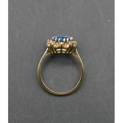 593 - A 9ct gold ladies oval cluster ring set with blue CZ surrounded by clear CZ stones, Size N/O, 3.5 gr... 