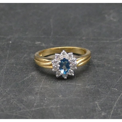 595 - A 9ct gold ladies oval cluster ring set with centre blue CZ surrounded by clear CZ stones, Size O/P,... 