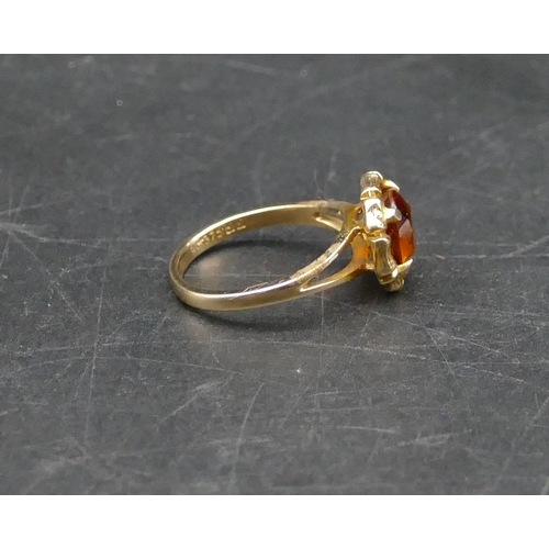 597 - A 9ct gold circular brandy coloured ladies citrine ring, Size N, 3.4 grams gross