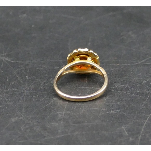 597 - A 9ct gold circular brandy coloured ladies citrine ring, Size N, 3.4 grams gross