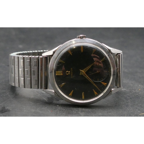 604 - An Omega gentleman's circular black-faced steel wristwatch with seconds dial, expanding strap bracel... 