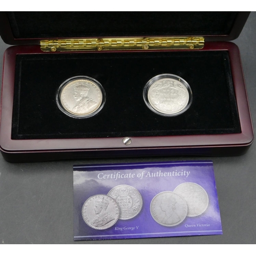 608 - A pair of silver King George V and Queen Victoria British India 1 Rupee, boxed with certificate