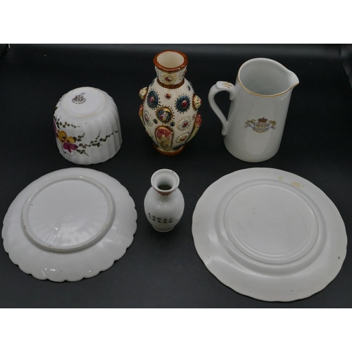 61 - A Victorian moustache cup and saucer on white ground with multi-coloured floral and leaf decoration,... 