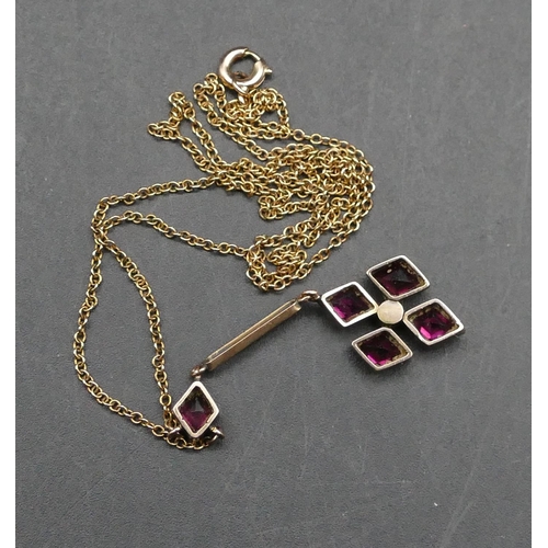 617 - A 9ct gold drop pendant with chain set with reddish/purple stones and centre half pearl, 42.5cm long... 