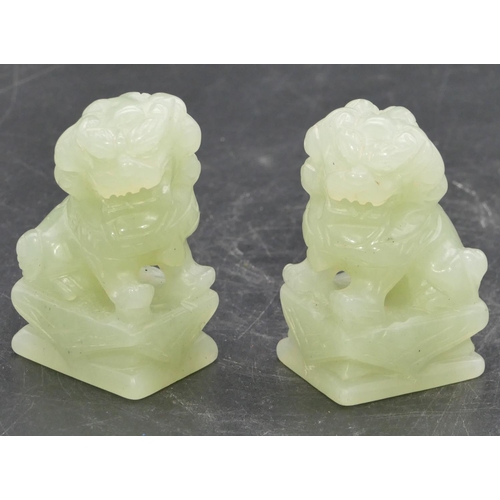 639 - A pair of green hardstone figures of seated dogs of Fo, 6.8cm high.