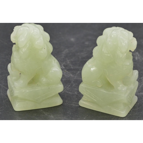 639 - A pair of green hardstone figures of seated dogs of Fo, 6.8cm high.