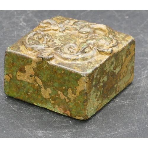 644 - A square hardstone seal with raised scroll top, 4.5cm wide.