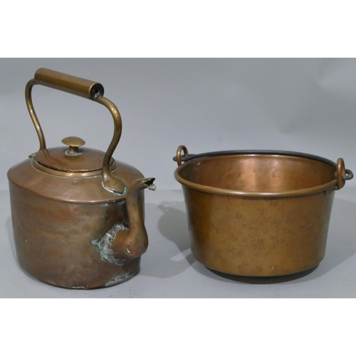 647 - A copper round pan with wrought ironed swing overhead handle, 27.5cm wide, an oval copper kettle wit... 