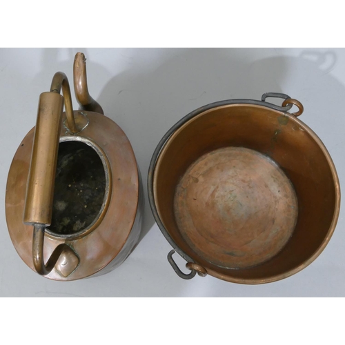 647 - A copper round pan with wrought ironed swing overhead handle, 27.5cm wide, an oval copper kettle wit... 