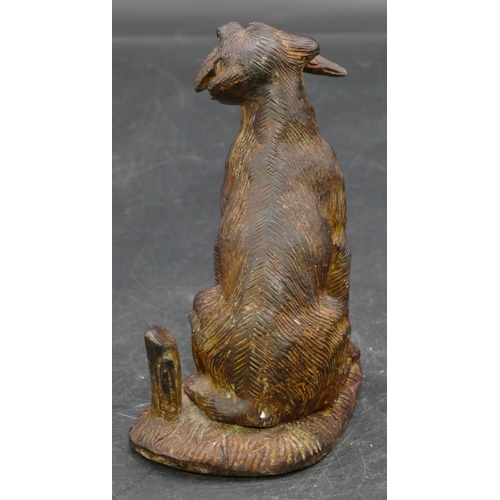 654 - A bronzed figure of a seated hunting dog, 12.5cm high.