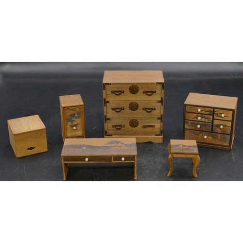 658 - A Japanese softwood miniature dolls house chest of drawers with metal mounts, 10cm high, a similar c... 