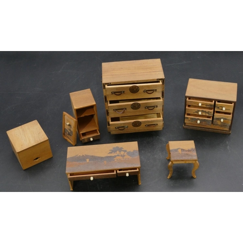 658 - A Japanese softwood miniature dolls house chest of drawers with metal mounts, 10cm high, a similar c... 