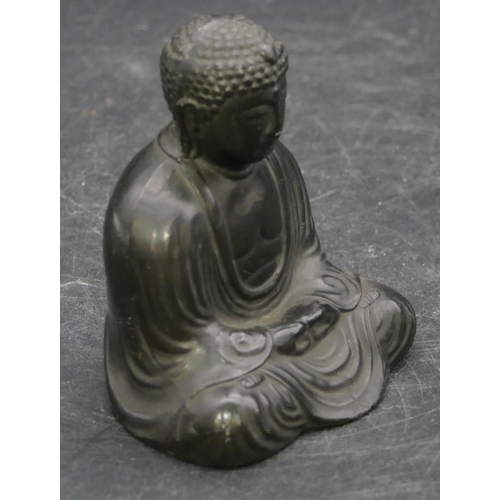 659 - A signed Oriental metal figure of seated Buddha, signed to base, 6cm high.