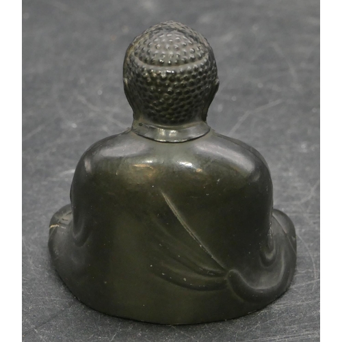 659 - A signed Oriental metal figure of seated Buddha, signed to base, 6cm high.