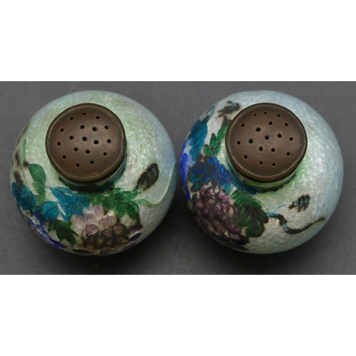 660 - A pair of Oriental enamelled round bulbous thin necked pepper pots with multi-coloured floral and le... 