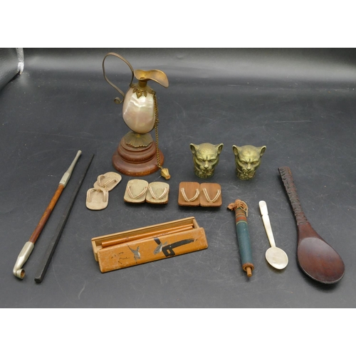 661 - 3 pairs of miniature dolls house shoes, an opium pipe, a carved wooden spoon, 2 metal cat head motif... 