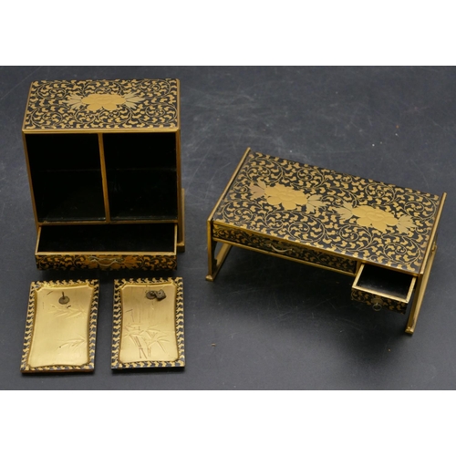 663 - An Oriental miniature black lacquered dolls house cabinet with allover gilt, floral, leaf and scroll... 