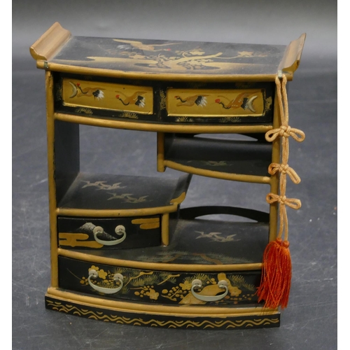 664 - An Oriental black lacquered miniature dolls house cabinet with allover gilt, crane, tree and floral ... 