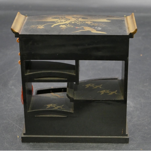 664 - An Oriental black lacquered miniature dolls house cabinet with allover gilt, crane, tree and floral ... 